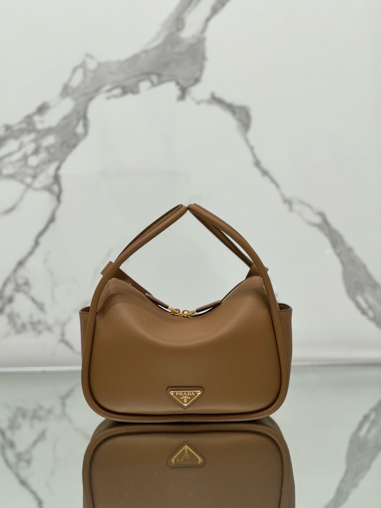 Pra*a top handle bag in caramel grained leather