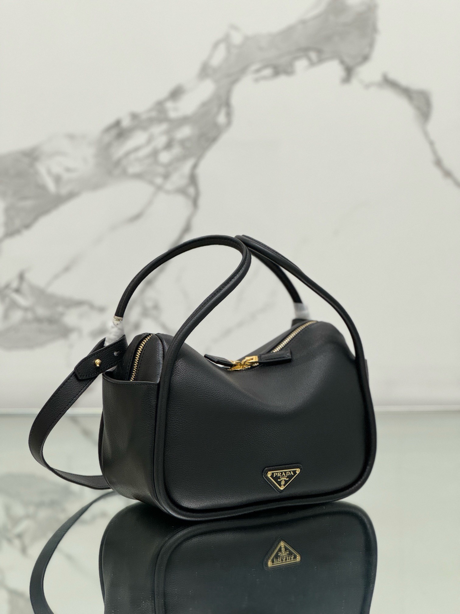 Pra*a top handle bag in black grained leather