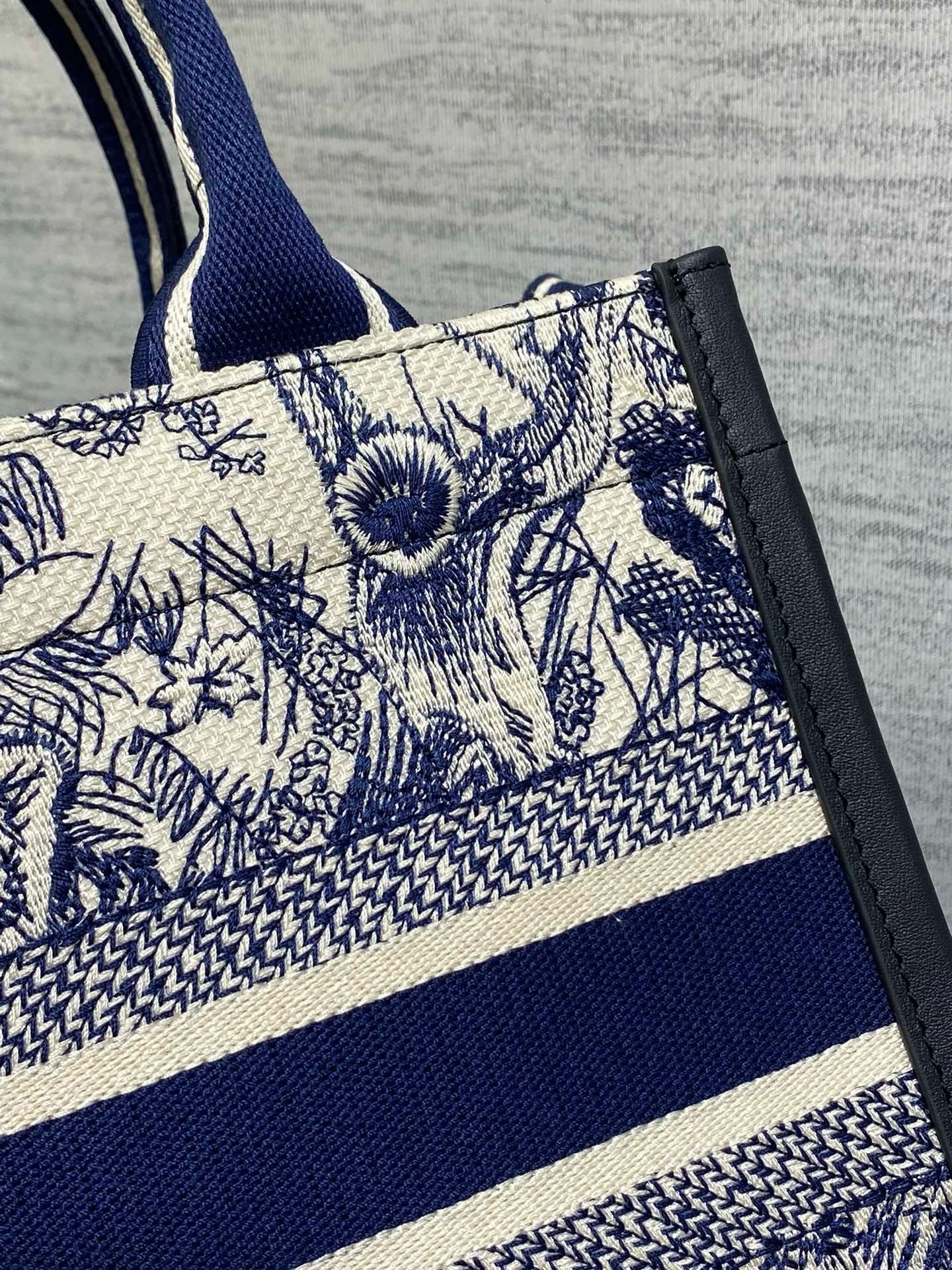 D*or small book tote bag with strap in toile de jouy sauvage embroidery with blue calfskin