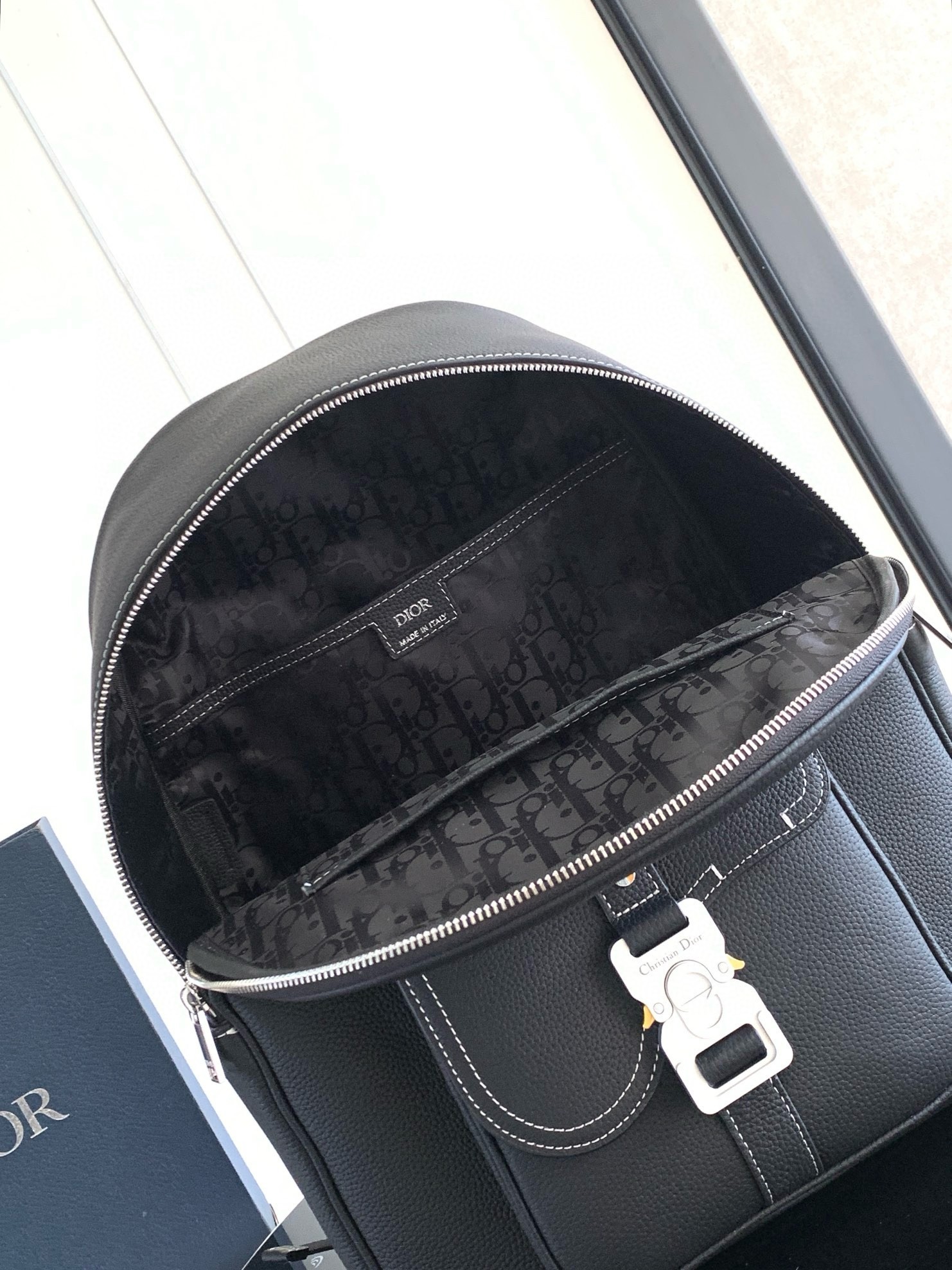 D*or saddle zip backpack in black grained calfskin